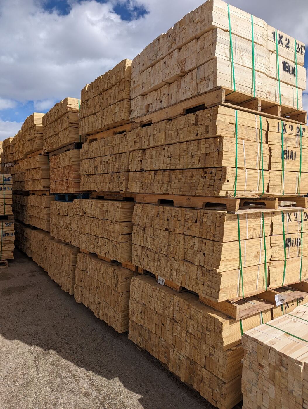 Pallets of milled hardwood stakes stacked high in the Basic Industries yard.